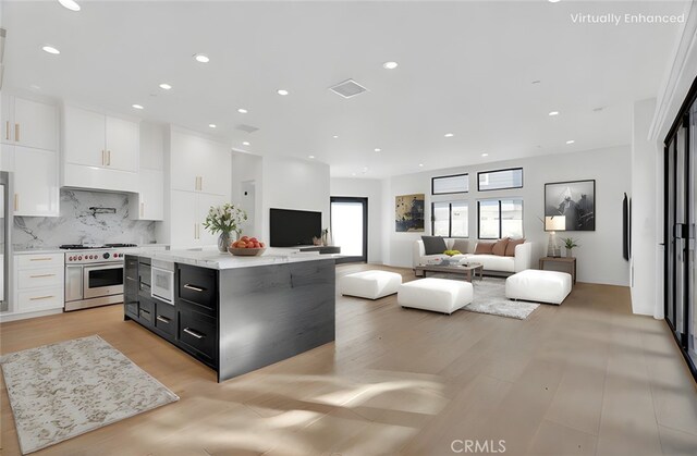 2319 Huntington Ln Unit A, Redondo Beach, CA 90278 - kitchen with double oven range, white cabinetry, backsplash, dark cabinets, and a center island