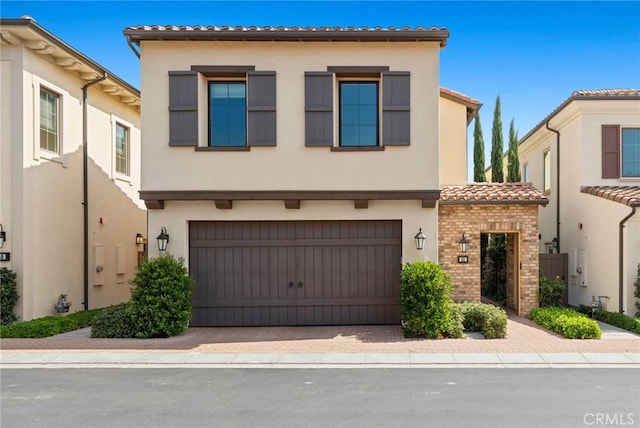 mediterranean / spanish house with a garage