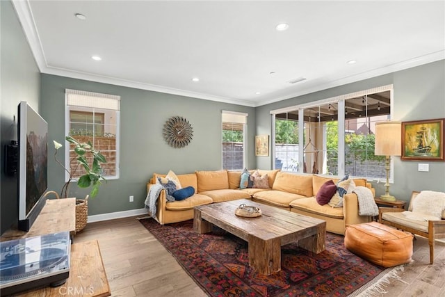 living room featuring hardwood / wood-style flooring and ornamental molding