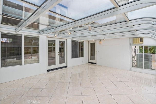 unfurnished sunroom featuring french doors