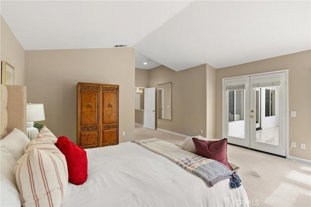 carpeted bedroom with access to exterior, vaulted ceiling, and french doors