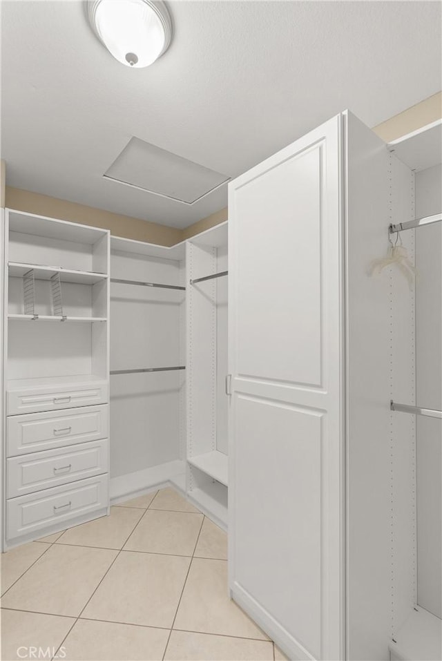 spacious closet with light tile patterned floors