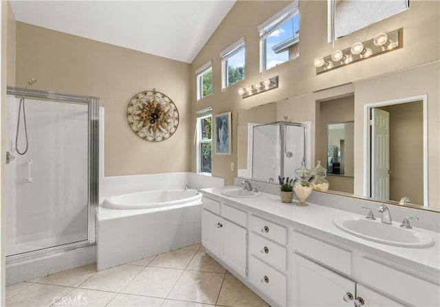 bathroom featuring shower with separate bathtub, vaulted ceiling, tile patterned floors, and vanity