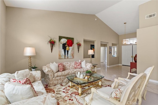 living room with light tile patterned floors and high vaulted ceiling