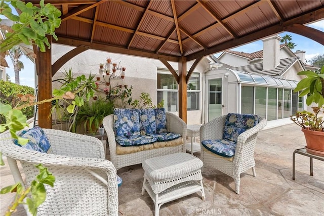 view of patio / terrace with a gazebo, outdoor lounge area, and a sunroom