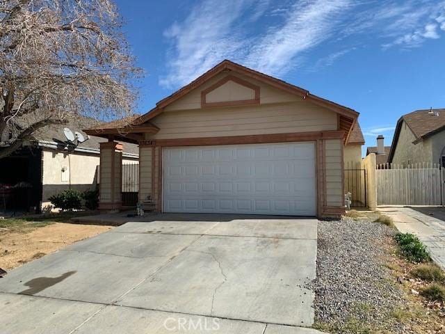 single story home featuring a garage, driveway, and fence