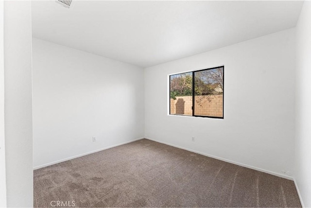 carpeted spare room with baseboards