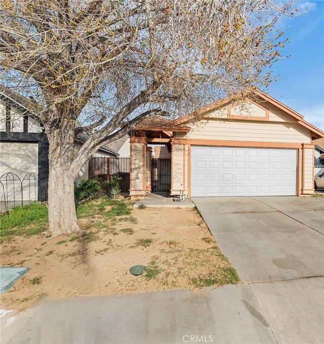 ranch-style home featuring an attached garage, fence, brick siding, and driveway