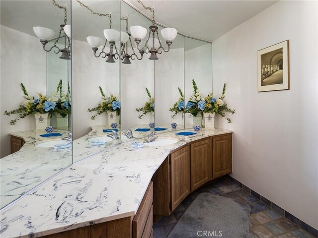 bathroom with vanity and a notable chandelier