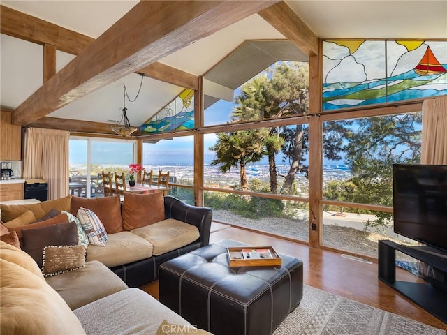 living room featuring wood-type flooring, floor to ceiling windows, and vaulted ceiling with beams