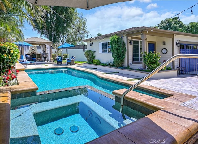 view of swimming pool with a patio area, fence, a fenced in pool, and an in ground hot tub