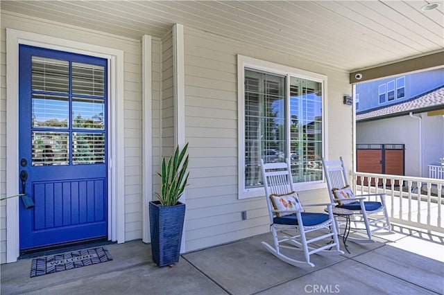 view of exterior entry with covered porch