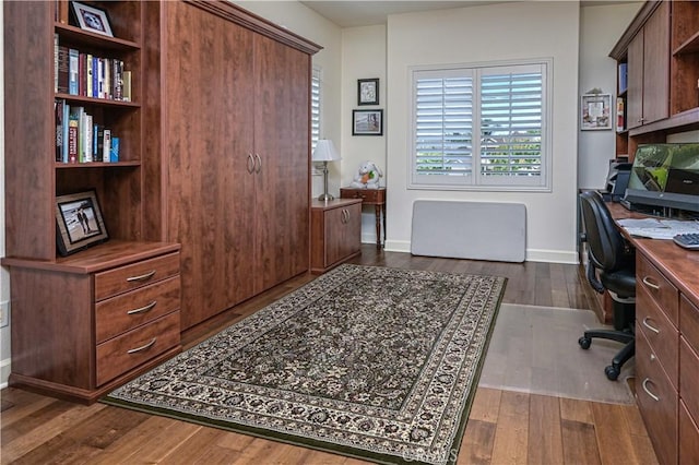 office area with baseboards and dark wood-style flooring