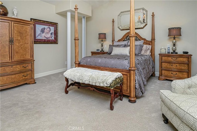 bedroom featuring light carpet and baseboards