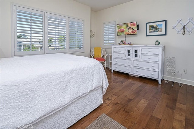 bedroom featuring dark wood-style flooring and baseboards