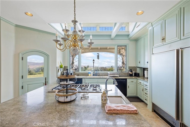 kitchen with a chandelier, recessed lighting, a sink, paneled built in fridge, and ornamental molding