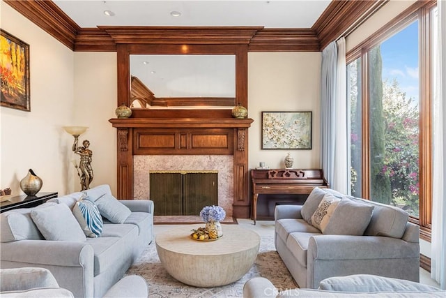 living room featuring ornamental molding and a high end fireplace