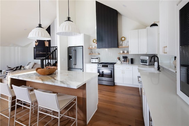kitchen featuring white cabinetry, stainless steel appliances, sink, and pendant lighting