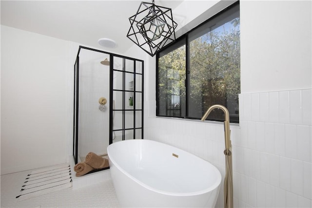 bathroom with independent shower and bath, tile walls, and tile patterned floors