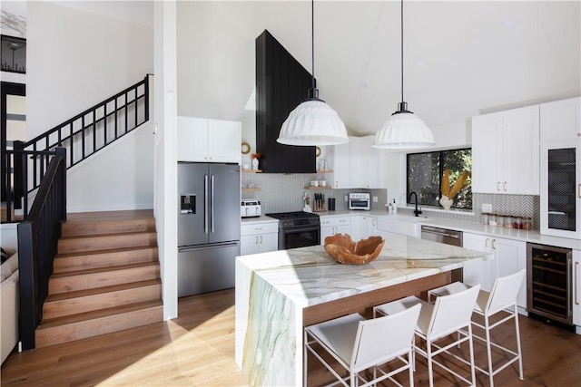 kitchen featuring white cabinetry, appliances with stainless steel finishes, and a center island