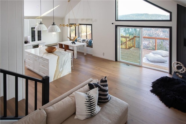 living room with a high ceiling and light wood-type flooring