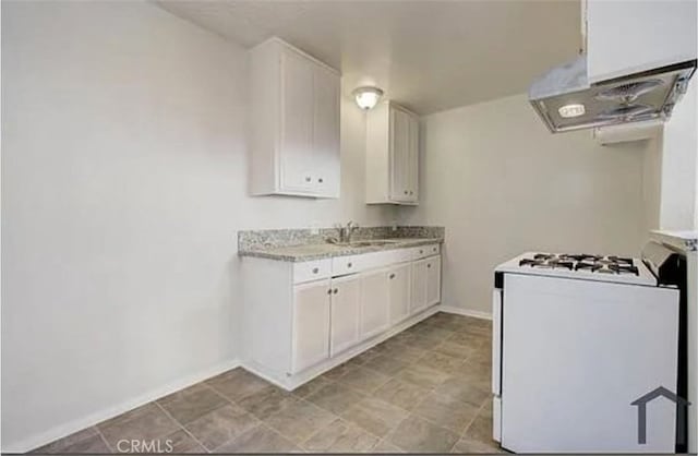 kitchen with white cabinetry, white gas range, sink, and range hood