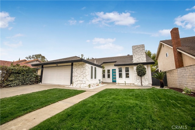 view of front of property featuring a garage and a front lawn