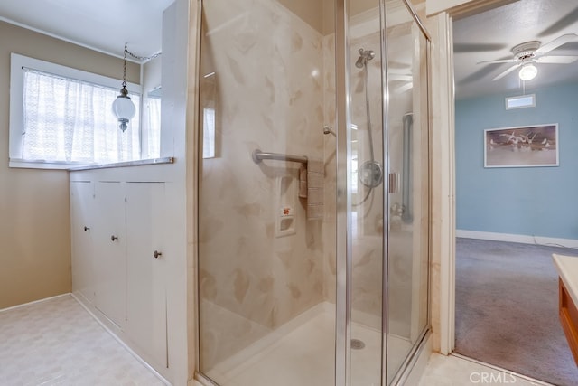 bathroom with ceiling fan and walk in shower