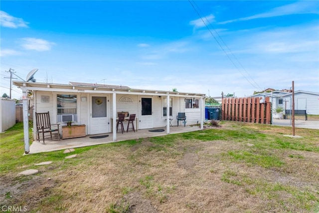 rear view of property featuring a yard and a patio