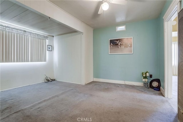 carpeted empty room featuring ceiling fan