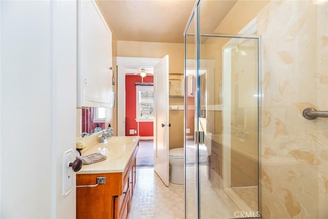 bathroom with vanity, an enclosed shower, and toilet