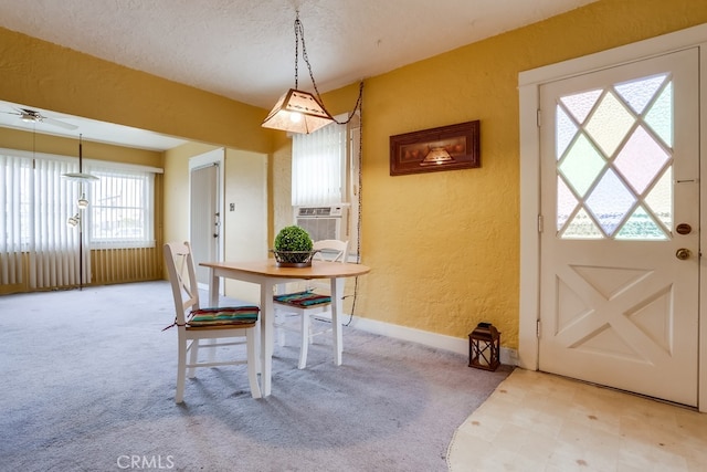 dining room with cooling unit, light carpet, and a textured ceiling