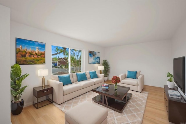 living area with baseboards and light wood-style flooring