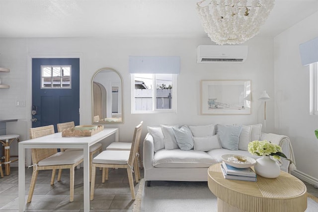 tiled living room featuring an AC wall unit and a notable chandelier