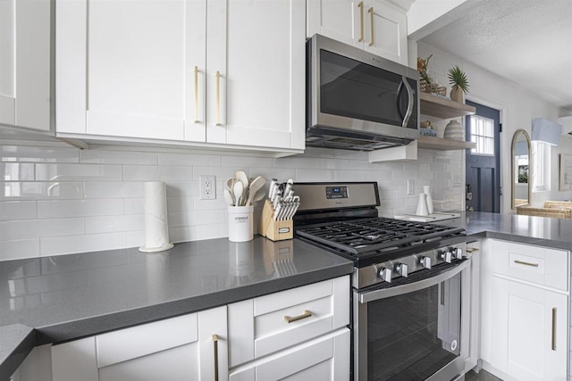 kitchen featuring white cabinetry, backsplash, and appliances with stainless steel finishes