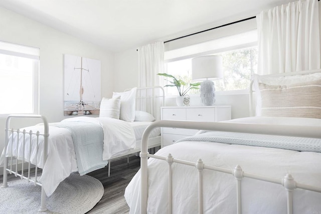 bedroom featuring lofted ceiling and light hardwood / wood-style flooring