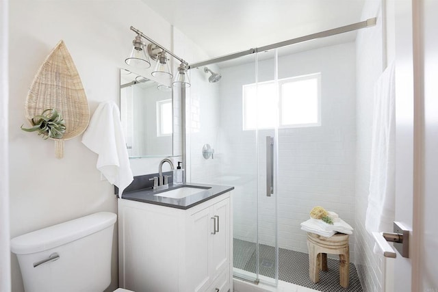 bathroom with vanity, toilet, and walk in shower