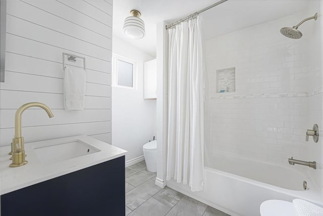 full bathroom featuring shower / bath combination with curtain, wooden walls, vanity, and toilet