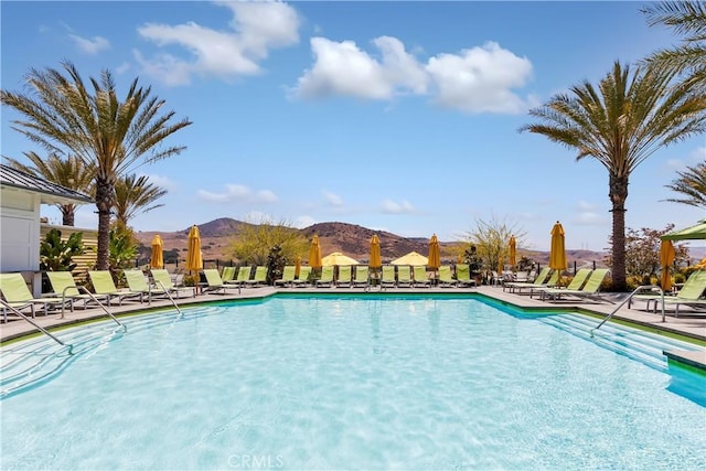 view of swimming pool featuring a mountain view and a patio area