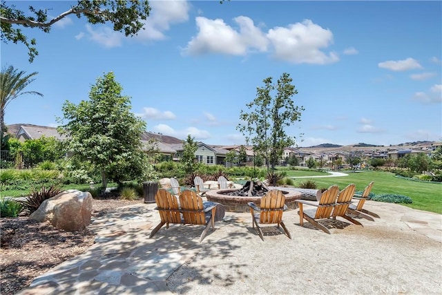 view of patio / terrace with a mountain view and a fire pit