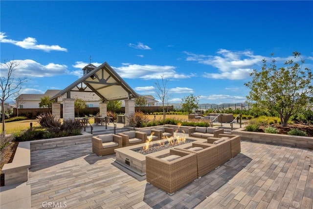 view of patio featuring a gazebo and an outdoor fire pit