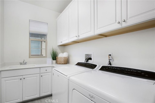 laundry room featuring sink, cabinets, and independent washer and dryer