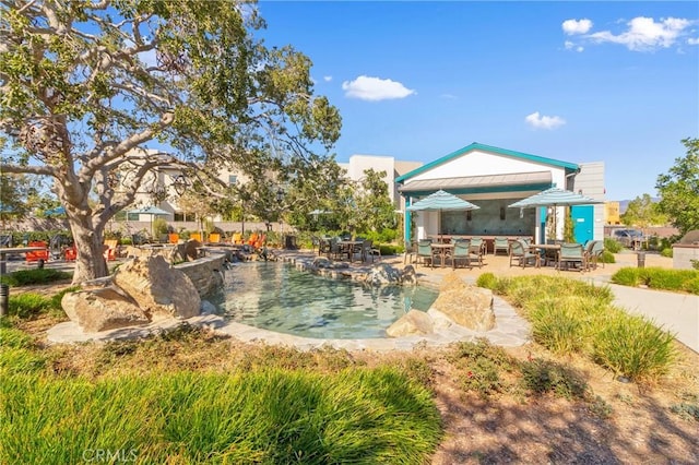 exterior space featuring a pool and a patio area