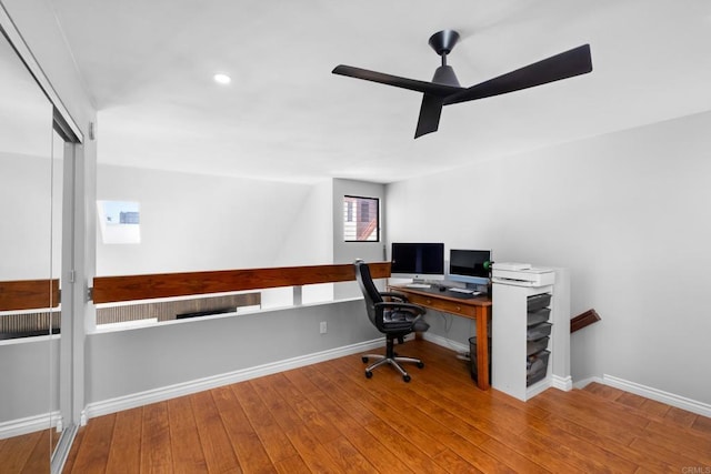 office with hardwood / wood-style flooring and ceiling fan