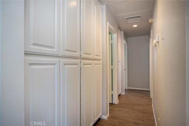 hallway with hardwood / wood-style flooring