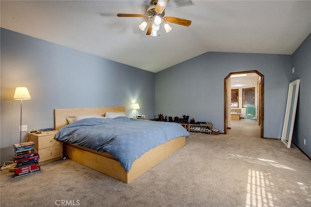 carpeted bedroom with ceiling fan and vaulted ceiling