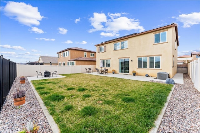 rear view of house featuring a lawn, a patio area, and central air condition unit