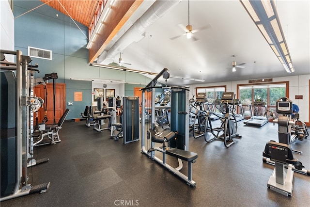 gym with high vaulted ceiling and ceiling fan