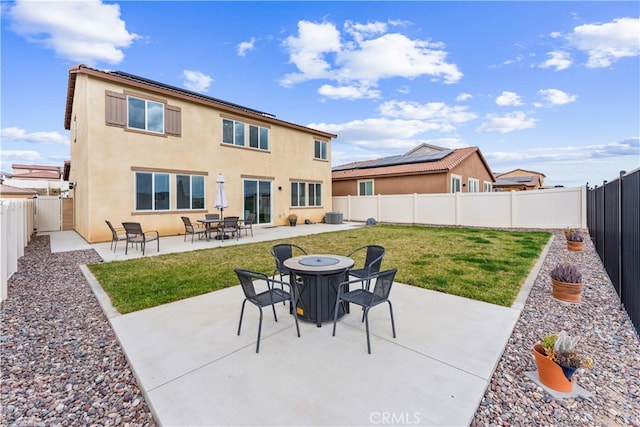 rear view of house featuring a yard, central AC, and a patio area