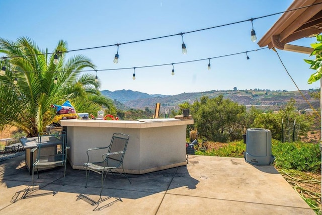 view of patio / terrace with a mountain view and exterior bar